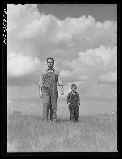 Youngest brother, Tom, takes Gene on a tour of the farm. Near Ames, Iowa