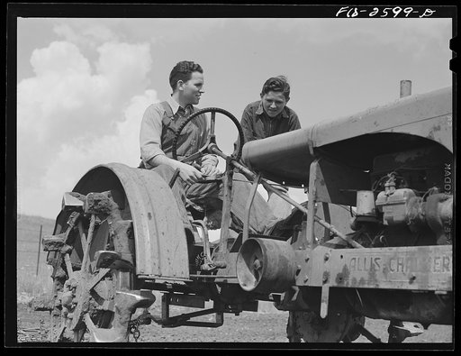 Untitled photo, possibly related to: Dale and Gene discuss some quirks the tractor has developed since Gene was home last. Near Ames, Iowa