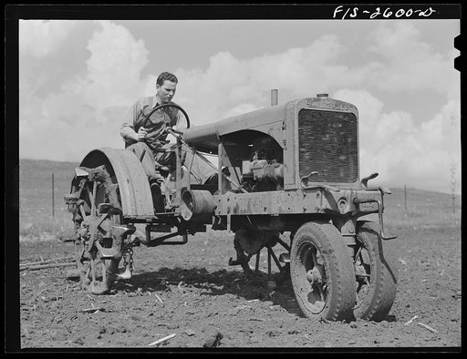 Gene tries his hand at the tractor. Near Ames, Iowa