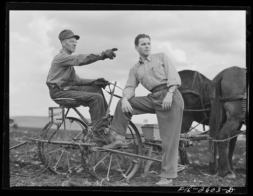 Gene discusses the condition of the farm with his father, who has been planting corn all day. Near Ames, Iowa