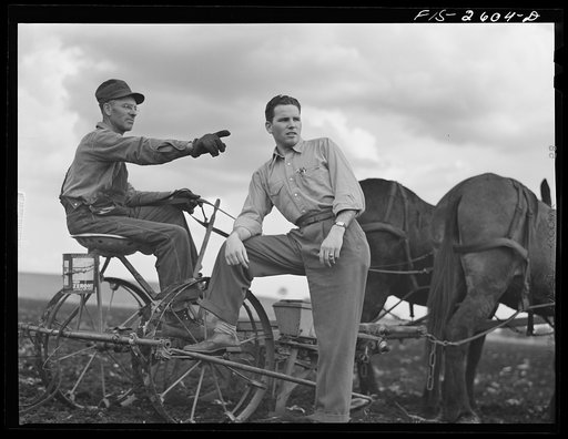 Untitled photo, possibly related to: Gene discusses the condition of the farm with his father, who has been planting corn all day. Near Ames, Iowa