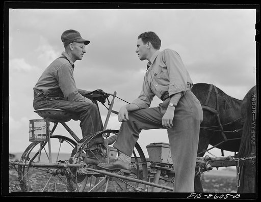Gene discusses the condition of the farm with his father, who has been planting corn all day. Near Ames, Iowa