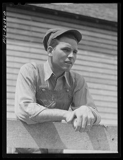 Gene Cooper, student at Iowa State College visits his family on their farm near Ames, Iowa
