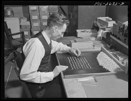 Professor G.F. Sprague of the Bureau of Plant Industry counting seed samples of Iowa hybrid corn. Agricultural Hall, Iowa State College. Ames, Iowa