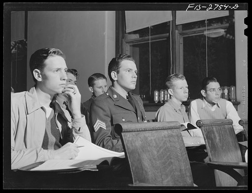 Gene has Reserve Officers' Training Corps (ROTC) classes later in the day, so he wears his uniform all day long. This is an agronomy class in agricultural hall. Iowa State College, Ames, Iowa