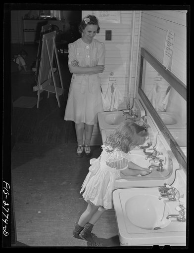 Emma Lou Musgrove, second year graduate student, looking after one of the children in the nursery at Iowa State College. Ames, Iowa