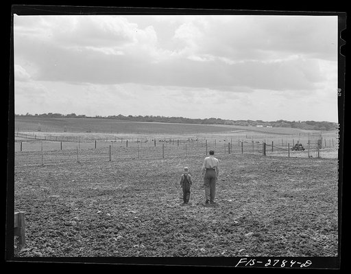 Youngest brother, Tom, takes Gene on a tour of the farm. Vicinity of Ames, Iowa