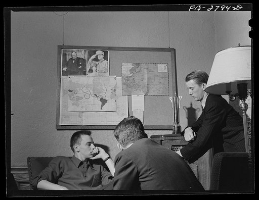 George Breckenbridge, left, forestry student, from Chicago, Illinois. Michael Deane (at radio), general agriculture, from Buenos Aires, Argentina, and Gene Bopp, poultry husbandry from Fergus Fall, Minnesota, listening to latest news reports in the lounge of the men's dormitory. Iowa State College, 