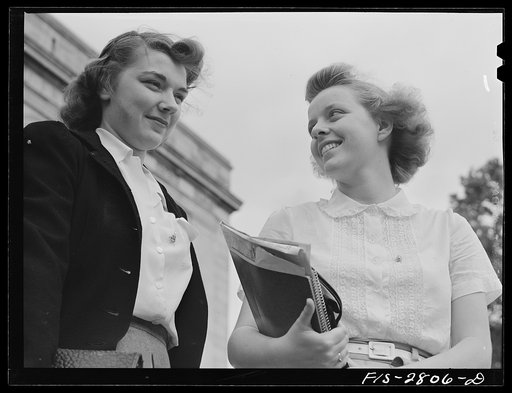 Untitled photo, possibly related to: Students coming out of the library at Iowa State College. Ames, Iowa