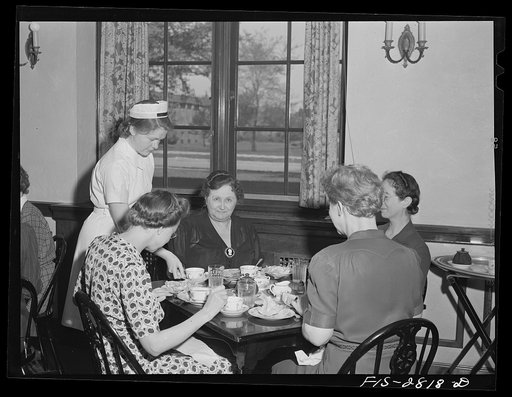 Home economics students learn to wait on tables in the home economics lunch room at Iowa State College. Ames, Iowa