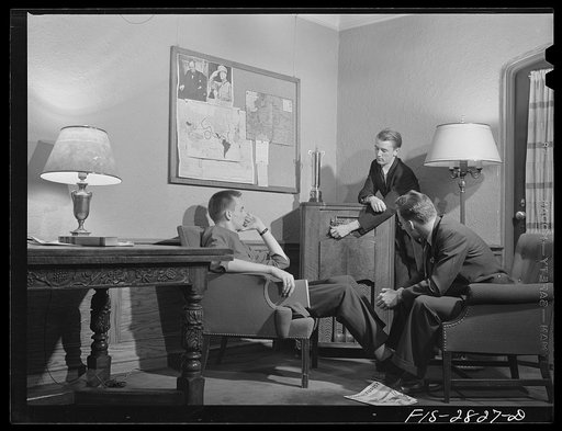 George Breckenridge, left, forestry student, from Chicago, Illinois, Michael Deane (at radio), general agriculture, from Buenos Aires, Argentina, and Gene Bopp, poultry husbandry, from Fergus Fall, Minnesota listening to latest news reports in the lounge of the men's dormitory at Iowa State College,