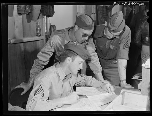 Operations department of pursuit squadron. These men take care of records and of other details necessary for operation of the pursuit squadron. Lake Muroc, California