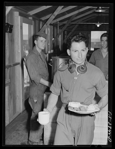 Sergeant pilot in training at noonday meal. Lake Muroc, California
