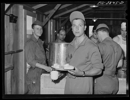 Sergeant pilot in training at noonday meal. Lake Muroc, California