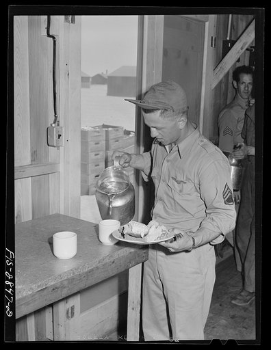 Sergeant pilot at noonday meal. Lake Muroc, California