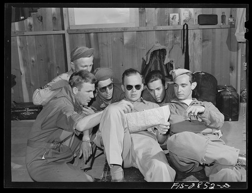 Untitled photo, possibly related to: Group of Sergeant pilots (Flying Sergeants) look at the map trying to decide where to go on weekly twenty-four hour leave