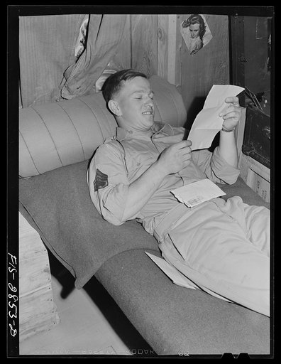 One of the "Flying Sergeants" reads a letter from home, Lake Muroc, California