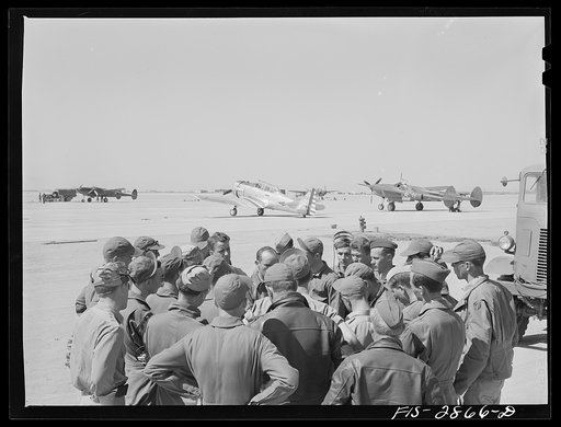 A lieutenant of a pursuit squadron explains an assignment to some of the "Flying Sergeants" at Lake Muroc, California