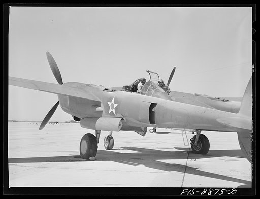 Working on the radio of an interceptor plane. Lake Muroc, California