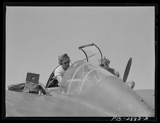 Untitled photo, possibly related to: Checking a radio in an interceptor plane. Lake Muroc, California
