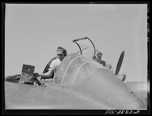 Checking a radio in an interceptor plane. Lake Muroc, California