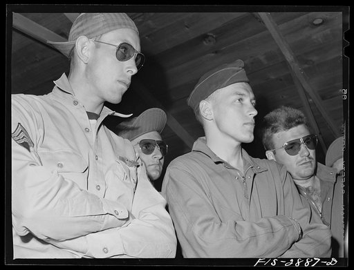 A few of the "Flying Sergeants" listen to an instructor at Lake Muroc, California
