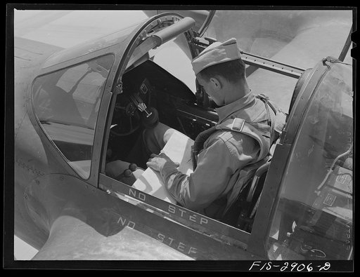 Pilot checks his records upon completion of flight at Lake Muroc, California