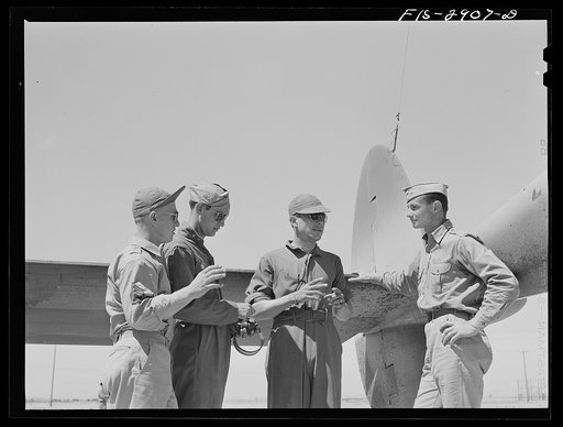 Some of the "Flying Sergeants" talk with their lieutenant instructor at Lake Muroc, California