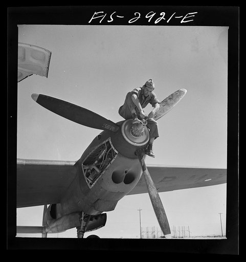 Working on the propeller hub of an interceptor plane. Lake Muroc, California