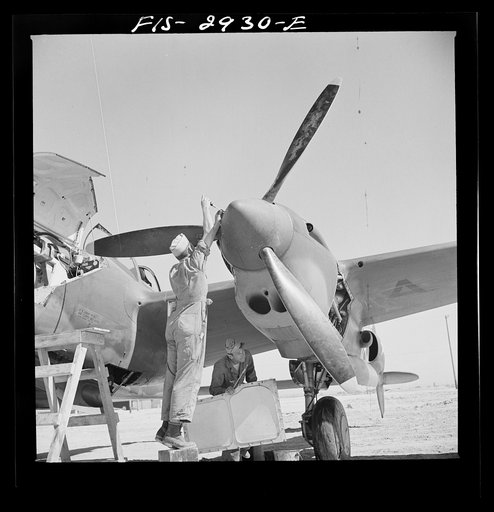 Untitled photo, possibly related to: Replacing propeller hub of interceptor plane. Lake Muroc, California