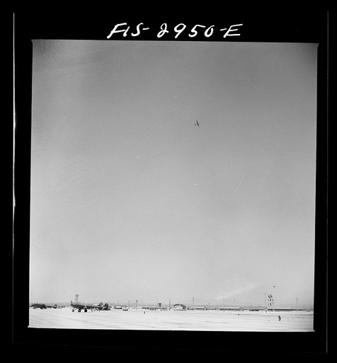 Untitled photo, possibly related to: "Buzzing" the field. Member of interceptor squadron swoops low over parked airplanes to stimulate a strafing attack on an airport. Lake Muroc, California