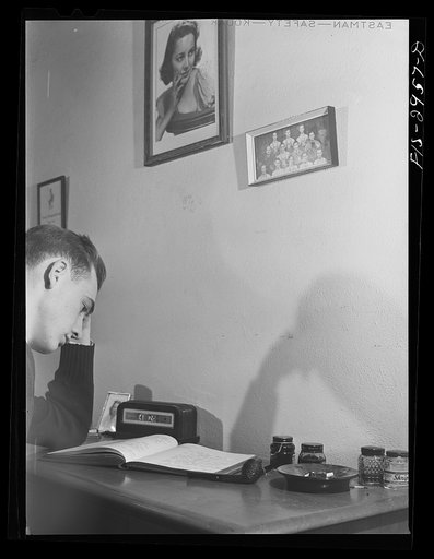 John Cockle in his room, studying for examinations. University of Nebraska, Lincoln