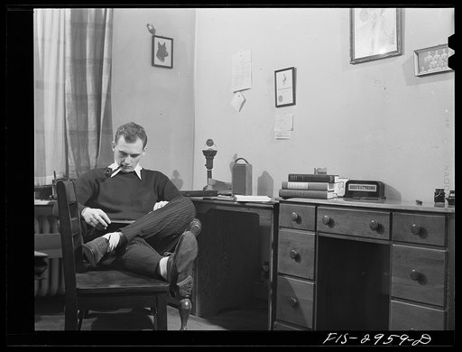 John Cockle in his room, studying for examinations. University of Nebraska, Lincoln