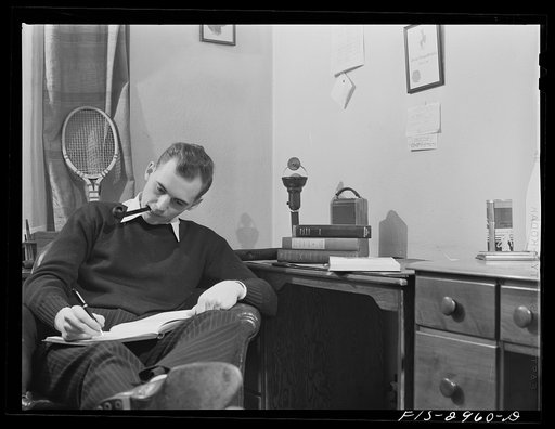 John Cockle in his room, studying for examinations. University of Nebraska, Lincoln