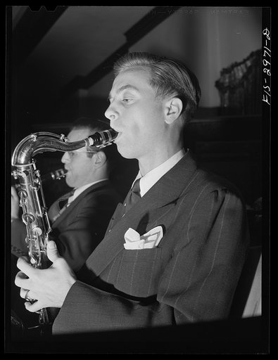 Jesse Younger playing saxophone in small band for a Saturday night dance. He has defrayed part of his college expenses this way for four years. University of Nebraska, Lincoln