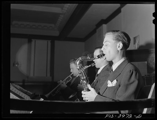 Untitled photo, possibly related to: Jesse Younger playing saxophone in small band for a Saturday night dance. He has defrayed part of his college expenses this way for four years. University of Nebraska, Lincoln