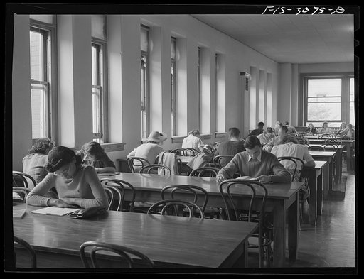 Bob Aden (at the second table) studying in the library. University of Nebraska, Lincoln