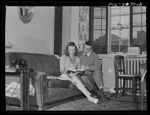 Bob Aden studying with his wife in their apartment. University of Nebraska, Lincoln