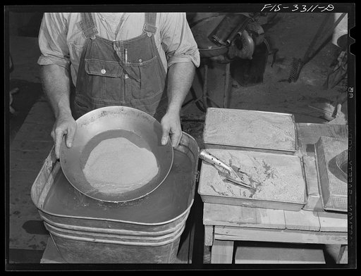 Untitled photo, possibly related to: Kern County, California. Mill of the Tungsten Chief Mine. Panning partly concentrated tungsten ore