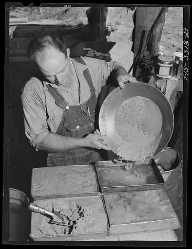 Untitled photo, possibly related to: Kern County, California. Mill of the Tungsten Chief Mine. Panning partly concentrated tungsten ore