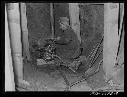 Kern County, California. Tungsten Chief Mine. Miner drilling a tungsten ore body before dynamiting