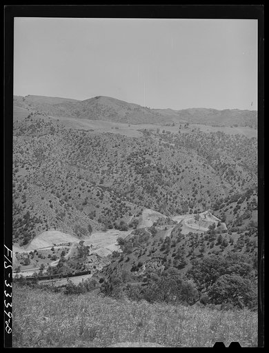 Kern County, California. Train going through a valley in the mountains