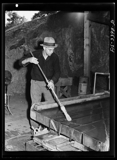 Kern County, California. Tungsten Chief Mill. Cleaning up the vibratory tables where tungsten ore is concentrated