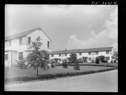 Untitled photo, possibly related to: Greenbelt, Maryland. Federal housing project. Two rows of gable-roofed houses on Ridge Road, showing front and backyards. Tenants must maintain their own grounds. All washing must be taken down from the outside lines by 4:00 p.m.