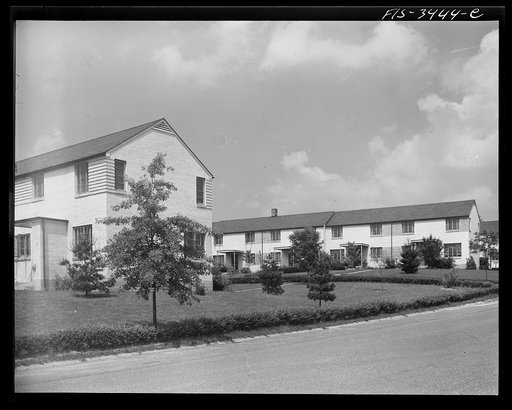 Greenbelt, Maryland. Federal housing project. Two rows of gable-roofed houses on Ridge Road, showing front and backyards. Tenants must maintain their own grounds. All washing must be taken down from the outside lines by 4:00 p.m.