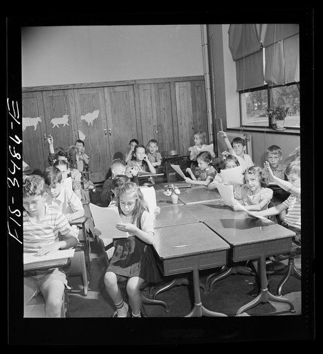 Greenbelt, Maryland. Federal housing project. Third grade children have a discussion about compositions which they have written