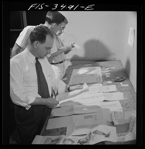 Greenbelt, Maryland. Federal housing project. Making up the Cooperator, the town's weekly news sheet which contains news and editorials of local interest. The editors volunteer their services in the evening. The paper, which is distributed free at every door on Thursdays, breaks even by selling adve
