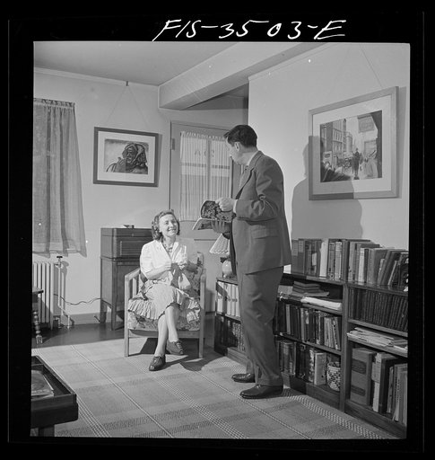 Greenbelt, Maryland. Federal housing project. Mr. and Mrs. Leslie Atkins in their living room discussing the seeds they plan to plant this year in their garden