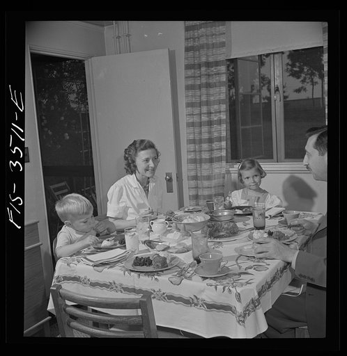 Greenbelt, Maryland. Federal housing project. Mr. and Mrs. Leslie Atkins, Ann, and Pierce Atkins having supper