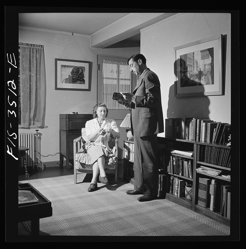 Untitled photo, possibly related to: Greenbelt, Maryland. Federal housing project. Mr. and Mrs. Leslie Atkins in their living room discussing the seeds they plan to plant this year in their garden